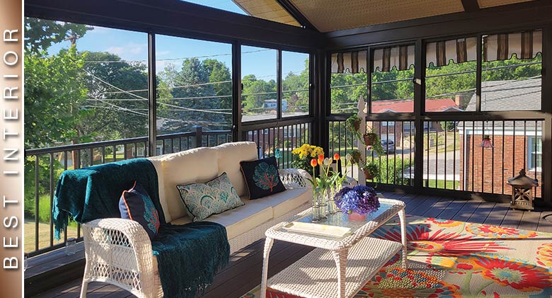 BEST INTERIOR: Brown, second-story screened deck enclosure w/white wicker sofa, coffee table, blue throw, flowers & plants.