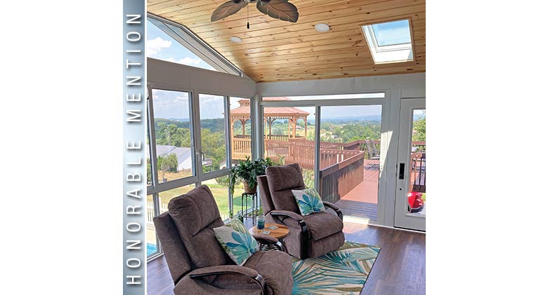 HONORABLE MENTION: Two brown recliners with floral print pillows in 2nd-story sunroom with skylight and wood ceiling.