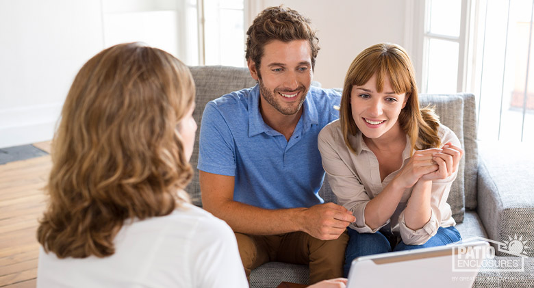 Design consultant making a sales presentation to a couple sitting on a sofa