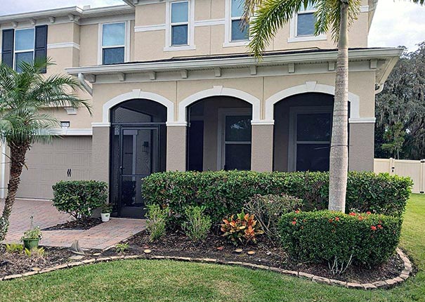 a beautiful 2 story house with a screened room