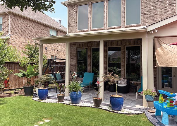 A covered porch with beautiful planters