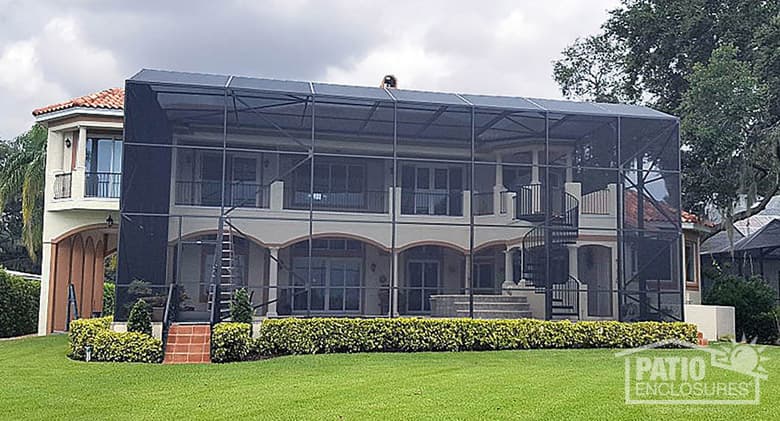 2-story screened pool enclosure with mansard roof in bronze.