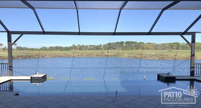 Screened pool enclosure with extreme view in bronze.