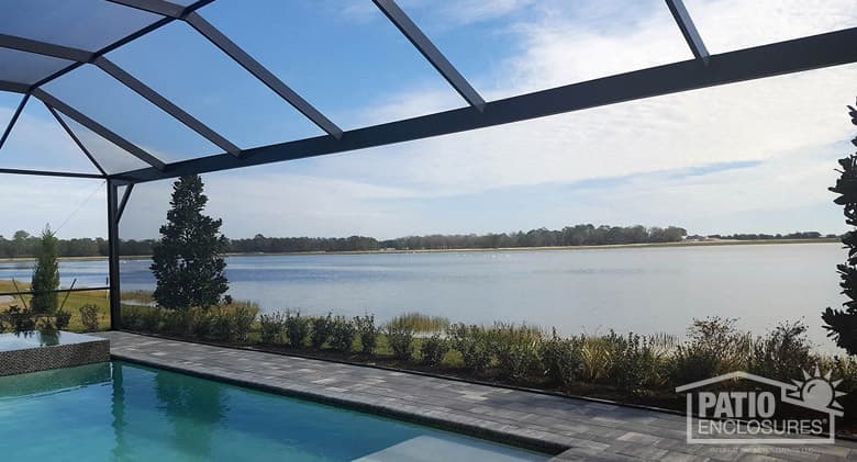 Screened pool enclosure with extreme view in bronze.