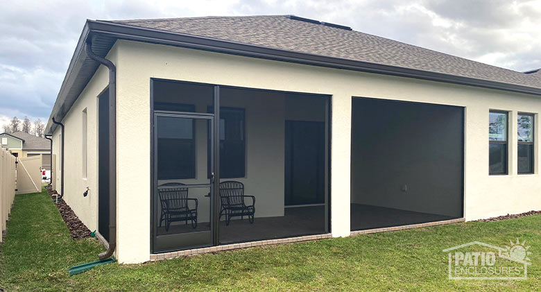 A corner porch or lanai enclosed with wall-to-wall screens.